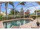 Screened-in pool with a seating area and lush tropical landscaping offer privacy at 4616 Blue Marlin Dr, Bradenton, FL 34208