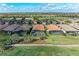 Stunning aerial view of homes with screened-in pools overlooking the lush golf course at 4632 Benito Ct, Lakewood Ranch, FL 34211