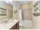 Neutral bathroom featuring a shower with tile surround and a vanity with solid surface countertops at 4632 Benito Ct, Lakewood Ranch, FL 34211