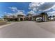 Grand entrance of a community center with porte-cochere, landscaping and walkway leading to the building entrance at 4632 Benito Ct, Lakewood Ranch, FL 34211