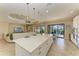 Spacious open-concept kitchen island with seating and view to the pool area provide an inviting space at 4632 Benito Ct, Lakewood Ranch, FL 34211