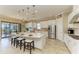 Modern kitchen with white cabinets, stainless steel appliances, and a large center island with seating at 4632 Benito Ct, Lakewood Ranch, FL 34211