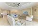 Bright and airy living room with a large sectional sofa and a view of the front entrance and dining area at 4632 Benito Ct, Lakewood Ranch, FL 34211