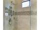 Modern shower with sleek fixtures, tile accents, and a glass enclosure for a refreshing experience at 4632 Benito Ct, Lakewood Ranch, FL 34211