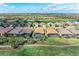 Aerial view of a house with a screened-in pool, showcasing its location near a golf course at 4632 Benito Ct, Lakewood Ranch, FL 34211