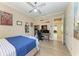 This bedroom features a ceiling fan, cool artwork and an ample desk area at 4632 Benito Ct, Lakewood Ranch, FL 34211