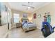 Comfortable bedroom features neutral walls, a ceiling fan, and a stylish wood-framed bed at 4632 Benito Ct, Lakewood Ranch, FL 34211