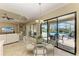 Cozy dining area with a view of the pool and outdoor patio through sliding glass doors at 4632 Benito Ct, Lakewood Ranch, FL 34211