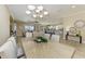 Formal dining area with chandelier that opens to kitchen, living room, and screened-in lanai with pool at 4632 Benito Ct, Lakewood Ranch, FL 34211