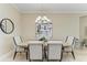 Well-lit dining area with marble table set beneath a decorative light fixture, adjacent to modern art at 4632 Benito Ct, Lakewood Ranch, FL 34211
