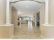 Spacious foyer featuring tile flooring, arches, and views of the living space, dining area, and screened-in lanai at 4632 Benito Ct, Lakewood Ranch, FL 34211