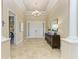 Bright foyer features tile flooring, modern chandelier, and decorative console table and mirror at 4632 Benito Ct, Lakewood Ranch, FL 34211