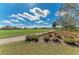 Scenic view of the golf course with lush green grass, blue skies, and scattered clouds at 4632 Benito Ct, Lakewood Ranch, FL 34211