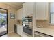 Gourmet kitchen area with stainless steel appliances, wine cooler and white cabinetry at 4632 Benito Ct, Lakewood Ranch, FL 34211