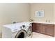 The laundry room features modern appliances, sleek countertops, and ample storage space at 4632 Benito Ct, Lakewood Ranch, FL 34211