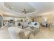 Open-concept living room and kitchen featuring white cabinets, tile floors, and modern furnishings at 4632 Benito Ct, Lakewood Ranch, FL 34211
