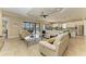 Bright living room featuring tile floors, recessed lighting, a large sectional sofa, and screened-in patio access at 4632 Benito Ct, Lakewood Ranch, FL 34211