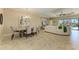 Open-concept living space features tile flooring, modern dining set, and comfortable seating area with a view of the pool at 4632 Benito Ct, Lakewood Ranch, FL 34211