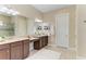 Well-lit main bathroom with double vanity, framed mirrors, and decorative lighting at 4632 Benito Ct, Lakewood Ranch, FL 34211