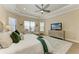 Spacious main bedroom featuring tray ceiling, ceiling fan, and large windows at 4632 Benito Ct, Lakewood Ranch, FL 34211