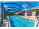 Enclosed pool with patio and chairs, complemented by well-maintained landscaping and blue skies at 4632 Benito Ct, Lakewood Ranch, FL 34211