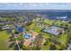 Aerial view of community park featuring tennis courts, playground, splash pad, and picnic areas surrounded by lush landscaping at 4724 Tilden Park Ct, Bradenton, FL 34211