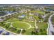 Aerial view of the community park with playground, splash pad, picnic areas, walking path, and sports field with lake views at 4724 Tilden Park Ct, Bradenton, FL 34211