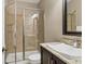 Bathroom features a tiled shower, glass door, and vanity with sleek faucet at 4724 Tilden Park Ct, Bradenton, FL 34211