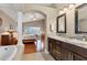 Elegant bathroom with double vanity, granite counters, and views to the Primary suite for ultimate relaxation at 4724 Tilden Park Ct, Bradenton, FL 34211