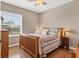 Cozy bedroom with natural light, a wooden bed frame, and side table lamps at 4724 Tilden Park Ct, Bradenton, FL 34211