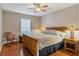 Comfortable bedroom with natural light, hardwood floors, and warm furnishings for a restful ambiance at 4724 Tilden Park Ct, Bradenton, FL 34211