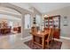 Cozy dining room with wooden table and chairs, complemented by a classic china cabinet and neutral décor at 4724 Tilden Park Ct, Bradenton, FL 34211