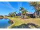 Beautiful backyard view with a screened-in lanai overlooking the lush landscaping and a tranquil lake at 4724 Tilden Park Ct, Bradenton, FL 34211