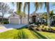 Inviting single-Gathering home featuring lush landscaping, a well-manicured lawn, and a spacious three-car garage at 4724 Tilden Park Ct, Bradenton, FL 34211