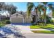 Charming single-Gathering home showcases a well-kept lawn, palm trees, and a convenient three-car garage at 4724 Tilden Park Ct, Bradenton, FL 34211
