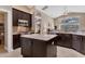 Open-concept kitchen with granite island, stainless appliances, and ample counter space, ideal for cooking and entertaining at 4724 Tilden Park Ct, Bradenton, FL 34211