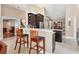 Modern kitchen featuring granite countertops, dark cabinets, stainless steel appliances, and a breakfast bar at 4724 Tilden Park Ct, Bradenton, FL 34211