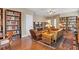 Inviting living room boasts bookshelves, hardwood floors, and stylish furniture at 4724 Tilden Park Ct, Bradenton, FL 34211