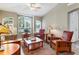 Cozy living room featuring comfortable seating, large windows, and stylish decor creating a relaxing atmosphere at 4724 Tilden Park Ct, Bradenton, FL 34211