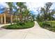 Scenic park pathway featuring a covered picnic area, lush landscaping, and a playground at 4724 Tilden Park Ct, Bradenton, FL 34211