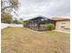 Spacious backyard with a screened-in pool area, lush landscaping, shed, and a white picket fence at 4839 Turtle Bay Ter, Bradenton, FL 34203