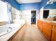 Bright bathroom with soaking tub, glass shower, double vanity, and walk-in closet at 4839 Turtle Bay Ter, Bradenton, FL 34203