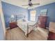 Bedroom with a decorative ceiling fan, a large window, and beach themed accents at 4839 Turtle Bay Ter, Bradenton, FL 34203