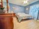 Bedroom with coastal decor, ceiling fan, and wood laminate flooring at 4839 Turtle Bay Ter, Bradenton, FL 34203