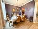 Elegant dining room with stylish chandelier, textured wallpaper, and arched entryway to kitchen at 4839 Turtle Bay Ter, Bradenton, FL 34203