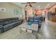 Open-concept living room with tile flooring, two sofas and views of the kitchen and dining area at 4839 Turtle Bay Ter, Bradenton, FL 34203