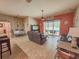 Open-concept living room with comfortable sofas, a ceiling fan and views of the backyard and adjacent dining area at 4839 Turtle Bay Ter, Bradenton, FL 34203