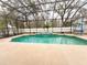 Inviting screened-in pool area with a waterfall feature and ample space for outdoor relaxation and entertaining at 4839 Turtle Bay Ter, Bradenton, FL 34203