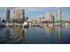 Scenic waterfront view with boats docked along the bay and city skyline at 4839 Turtle Bay Ter, Bradenton, FL 34203