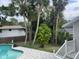 Backyard swimming pool featuring a stone paver patio and stairs at 4868 Featherbed Ln, Sarasota, FL 34242